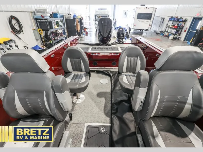 Slide: The Image of Interior of a 2025 Evolution 221 boat with gray seating, displayed at Bretz RV & Marine. - 15
