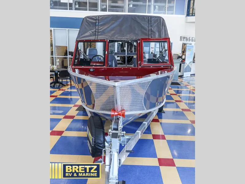 Slide: The Image of 2025 Evolution 221 boat on display at Bretz RV & Marine showroom. - 2