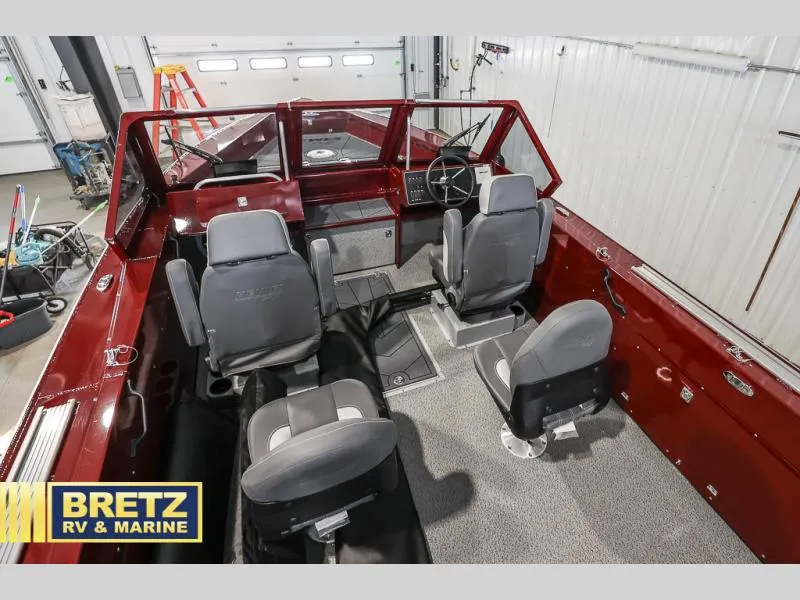 Slide: The Image of Interior of a 2025 Evolution 221 boat with four seats and steering wheel. - 21