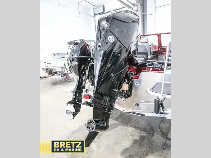 Slide: The Image of 2025 Evolution 221 boat motor in showroom, featuring sleek black design. - 25