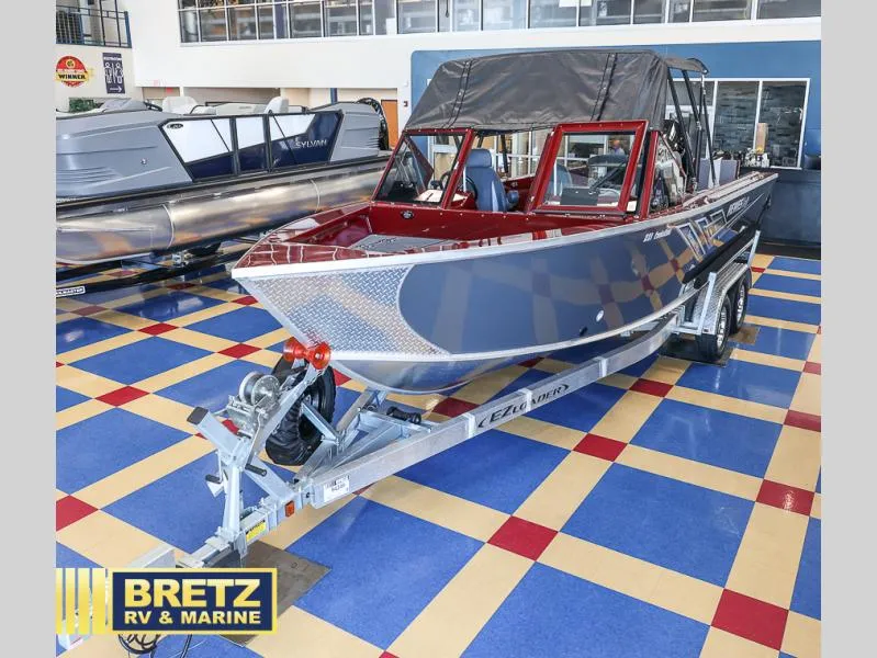 Slide: The Image of 2025 Evolution 221 boat on trailer at Bretz RV & Marine showroom. - 3