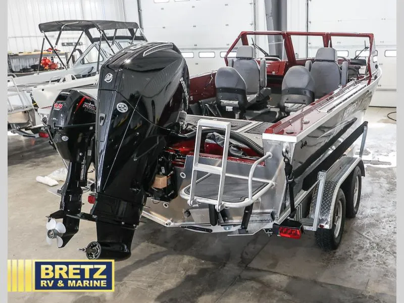 Slide: The Image of 2025 Evolution 221 boat with dual outboard motors in a showroom. - 31