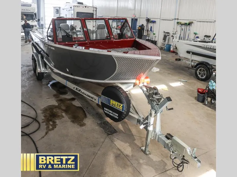 Slide: The Image of 2025 Evolution 221 boat on trailer at Bretz RV & Marine showroom. - 32