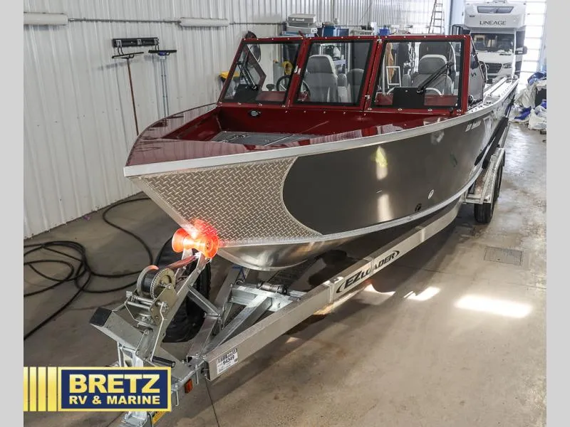 Slide: The Image of 2025 Evolution 221 boat on trailer in indoor showroom at Bretz RV & Marine. - 33