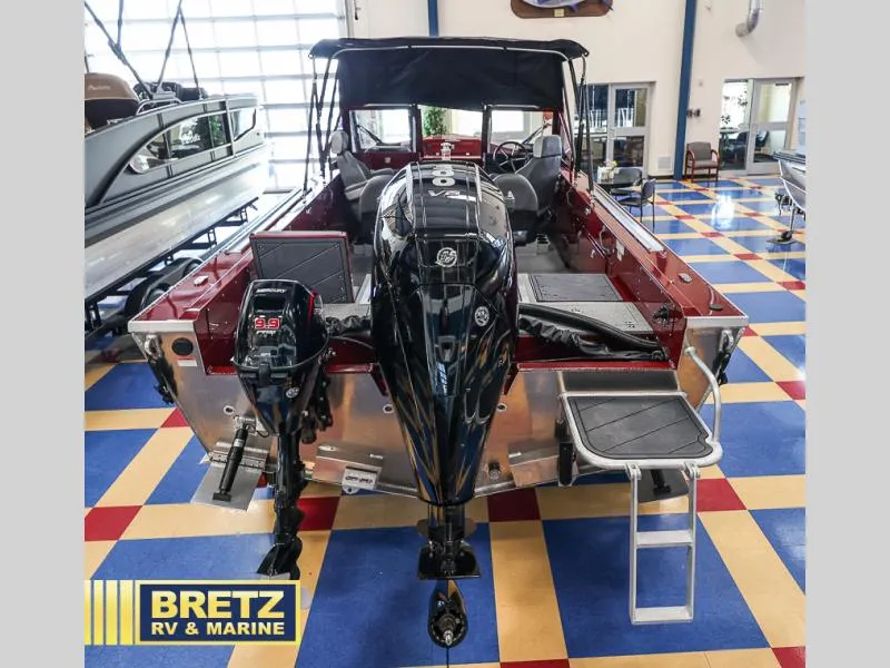 Slide: The Image of 2025 Evolution 221 boat with dual outboard motors displayed at Bretz RV & Marine showroom. - 5