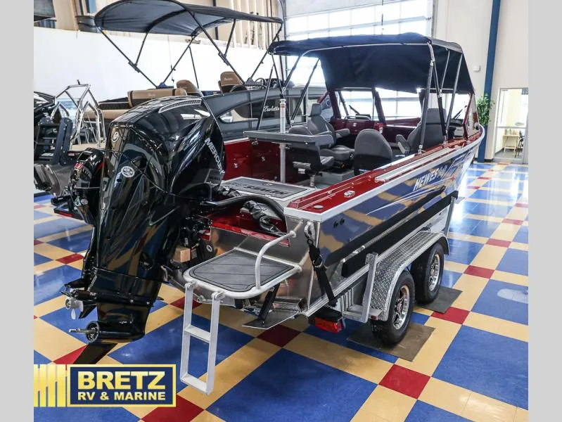 Slide: The Image of 2025 Evolution 221 boat with outboard motor on display at Bretz RV & Marine showroom. - 6