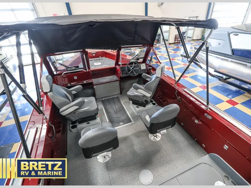 Slide: The Image of Interior of 2025 Evolution 221 boat with seating and steering wheel, displayed at Bretz RV & Marine. - 8