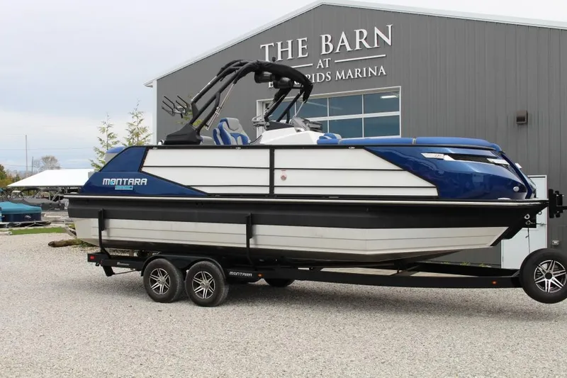 The Image of 2025 Montara Surf Boss CW 25' boat on trailer at marina. - 1