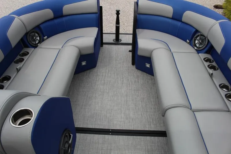 Slide: The Image of 2025 Montara Surf Boss CW 25' interior with blue and gray seating, cup holders, and speakers. - 6