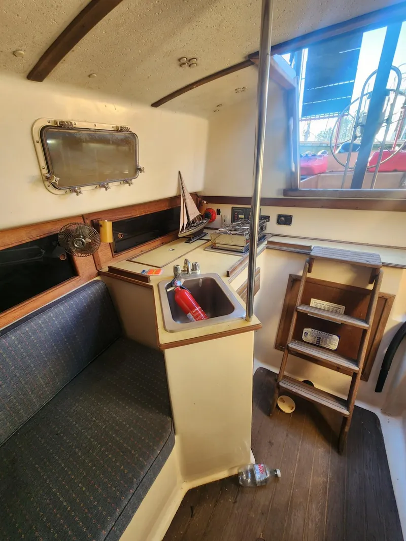 Slide: The Image of Interior of 1982 Watkins 27 Pirate Ship with kitchenette and seating area. - 14