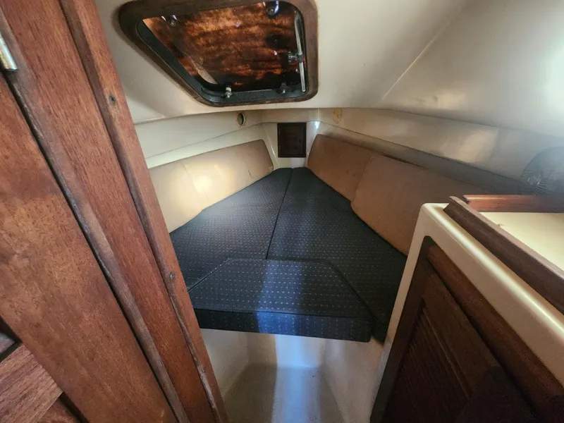 Slide: The Image of Interior cabin of 1982 Watkins 27 Pirate Ship, featuring cozy sleeping area. - 15