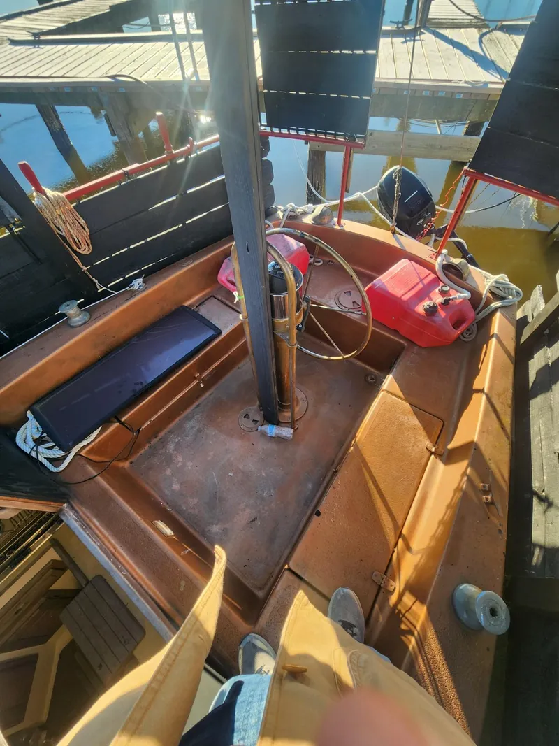 Slide: The Image of 1982 Watkins 27 Pirate Ship sailboat cockpit with nautical equipment and dock view. - 20