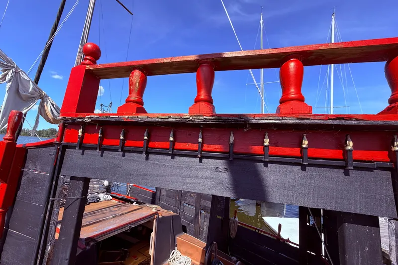 Slide: The Image of Outboard motor on 1982 Watkins 27 Pirate Ship, docked in calm water. - 21