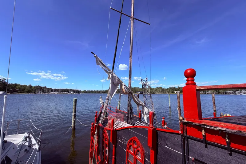 Slide: The Image of Interior of 1982 Watkins 27 Pirate Ship, featuring cozy seating and nautical equipment. - 26