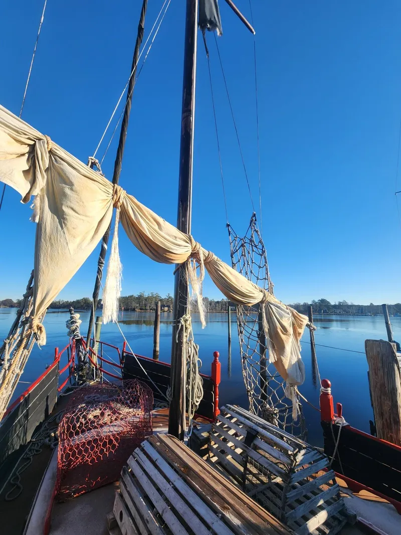 Slide: The Image of Interior of 1982 Watkins 27 Pirate Ship with kitchenette and seating area. - 27
