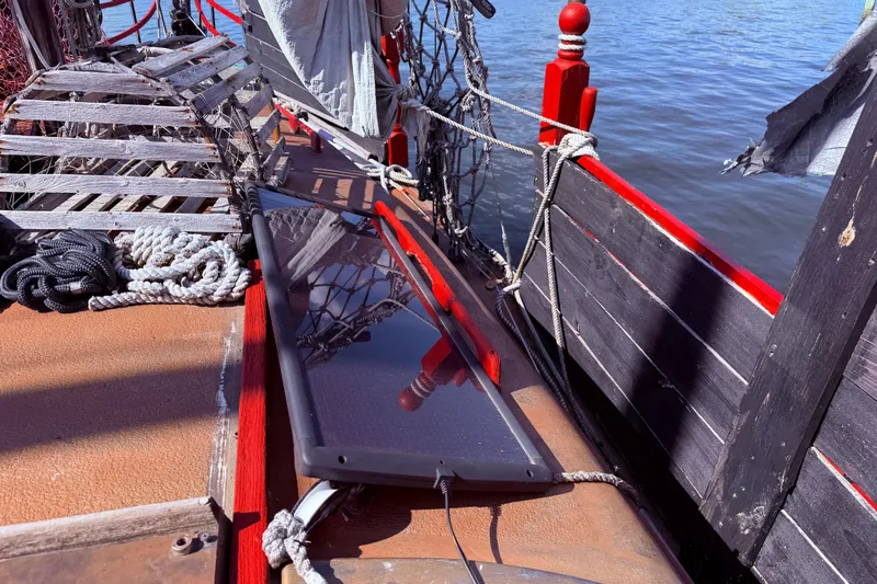 Slide: The Image of 1982 Watkins 27 Pirate Ship sailboat cockpit with nautical equipment and dock view. - 33