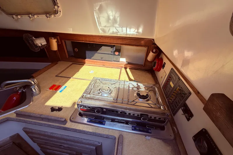 Slide: The Image of Interior of 1982 Watkins 27 Pirate Ship with stove and control panel. - 36