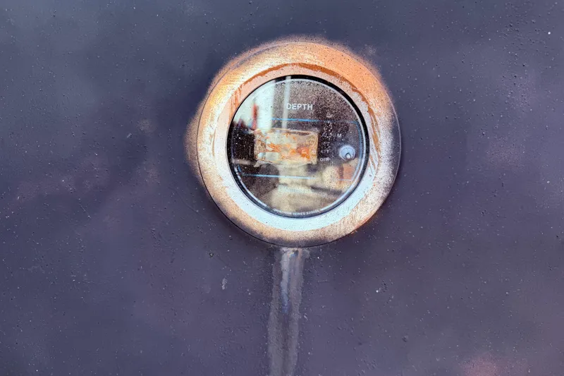 Slide: The Image of Depth gauge on 1982 Watkins 27 Pirate Ship, showing weathered exterior. - 41