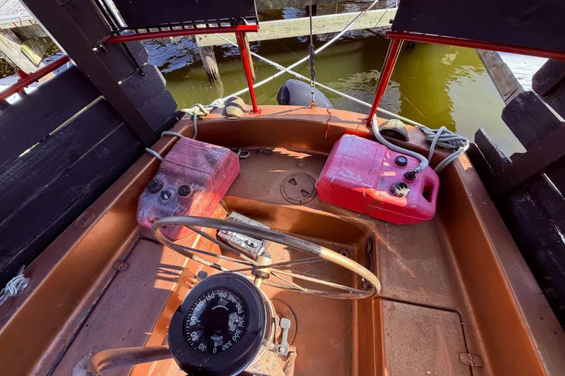 Slide: The Image of Interior of a 1982 Watkins 27 Pirate Ship with steering wheel and compass. - 44