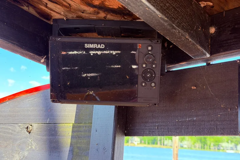 Slide: The Image of Simrad navigation device on 1982 Watkins 27 Pirate Ship, mounted under wooden structure. - 45