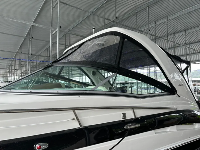 Slide: The Image of 2020 Crownline 330 SY boat under covered dock, side view. - 11