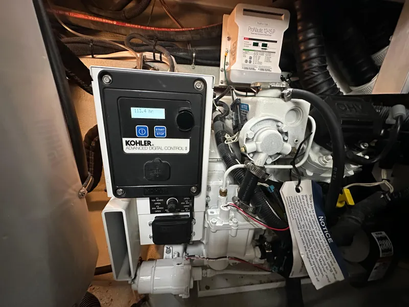 Slide: The Image of Kohler generator control panel in 2020 Crownline 330 SY boat engine room. - 13