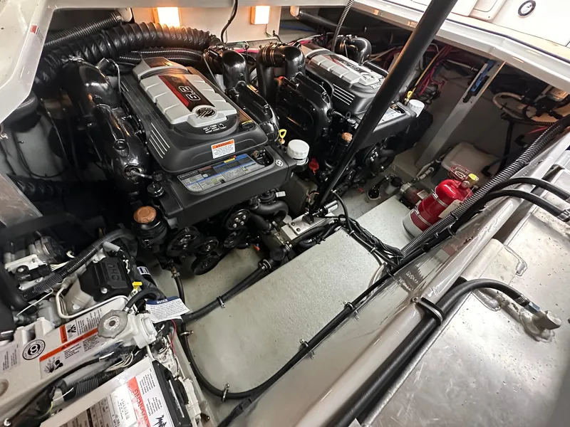 Slide: The Image of Engine room of 2020 Crownline 330 SY boat, showcasing dual engines and mechanical components. - 15
