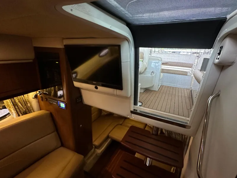 Slide: The Image of Interior of 2020 Crownline 330 SY yacht with TV and seating area. - 18