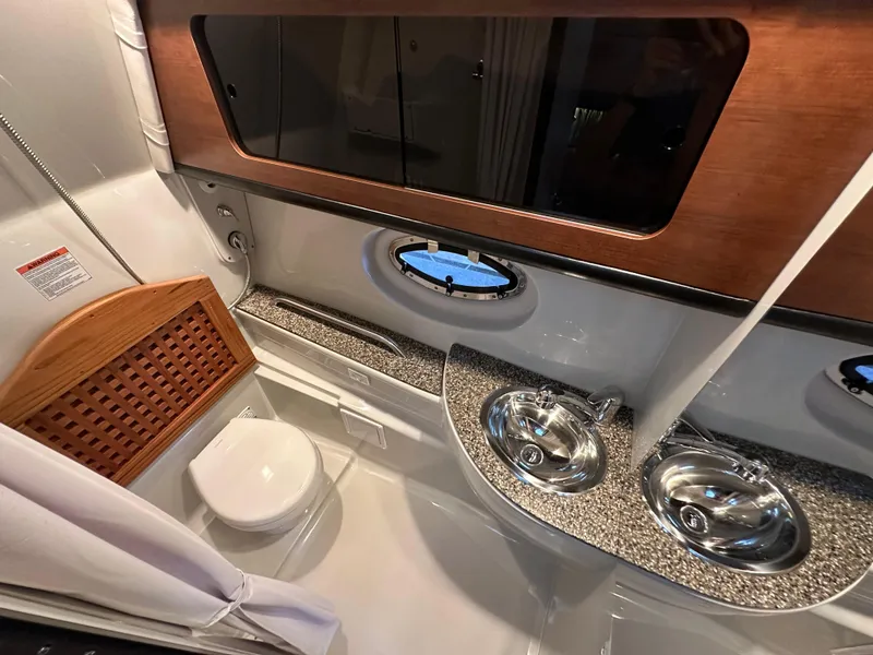 Slide: The Image of Luxurious bathroom in 2020 Crownline 330 SY yacht with dual sinks and modern fixtures. - 22