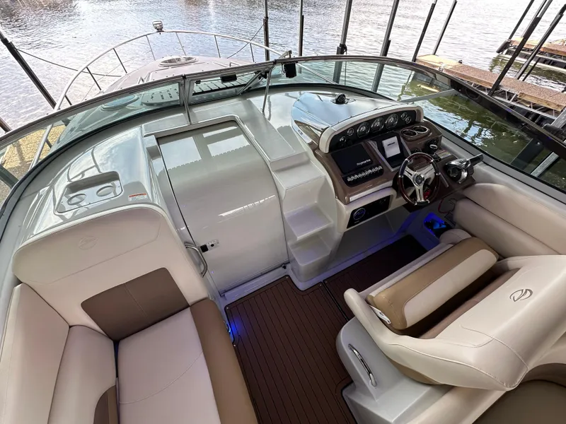 Slide: The Image of 2020 Crownline 330 SY boat cockpit with modern controls and comfortable seating. - 28