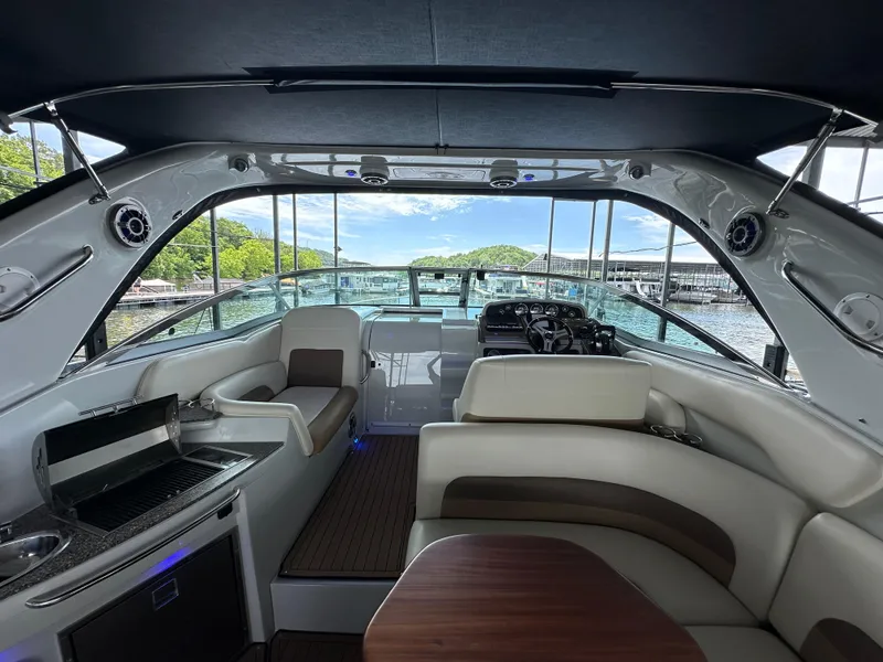 Slide: The Image of Interior of 2020 Crownline 330 SY yacht with luxurious seating and scenic water view. - 30