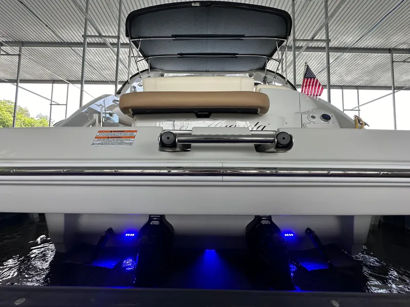 Slide: The Image of Crownline 330 SY 2020 boat with blue underwater lights in a covered dock. - 34