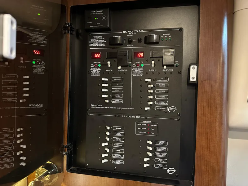 Slide: The Image of Electrical panel inside 2020 Crownline 330 SY boat, showing voltage and circuit breakers. - 36