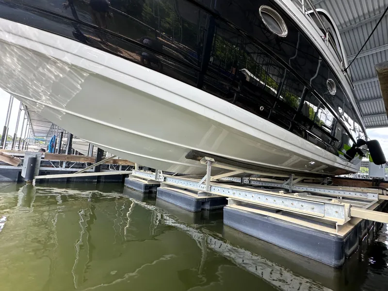 Slide: The Image of 2020 Crownline 330 SY boat on lift in marina. - 37
