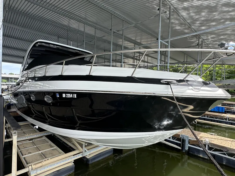 Slide: The Image of 2020 Crownline 330 SY boat docked under a covered marina. - 38