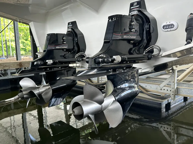 Slide: The Image of Crownline 330 SY 2020 model with dual MerCruiser outdrives in a marina setting. - 39