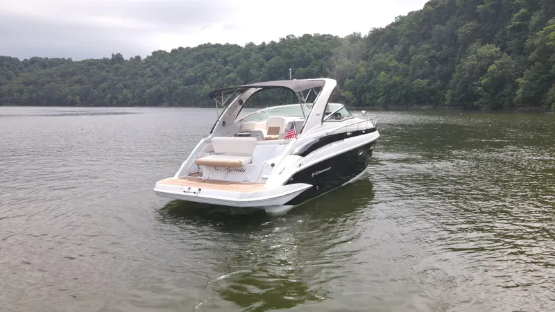 Slide: The Image of 2020 Crownline 330 SY boat cruising on a scenic lake. - 4