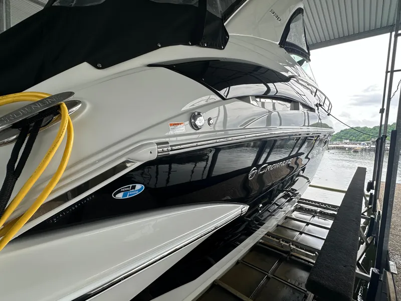 Slide: The Image of 2020 Crownline 330 SY yacht docked in a marina, side view. - 7