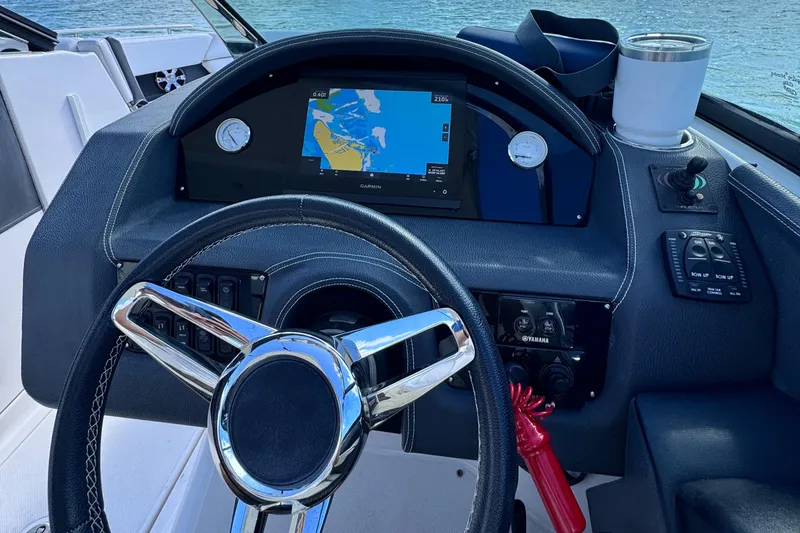 Slide: The Image of 2018 Regal 29 OBX boat dashboard with navigation display and steering wheel. - 17