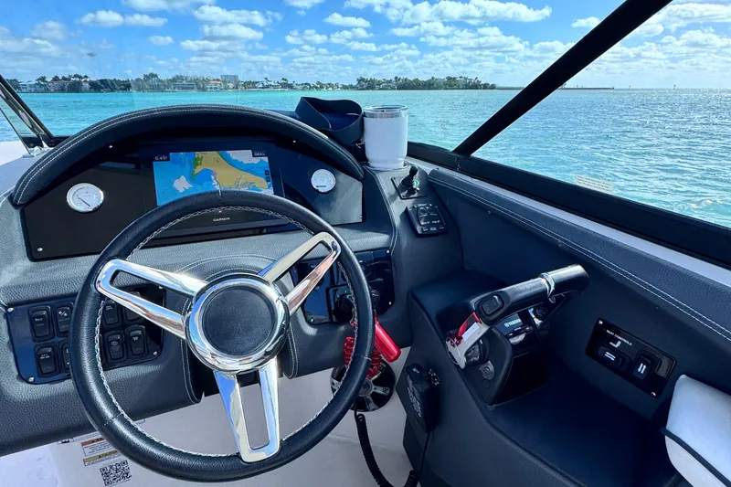 Slide: The Image of 2018 Regal 29 OBX boat dashboard with steering wheel and navigation system. - 18
