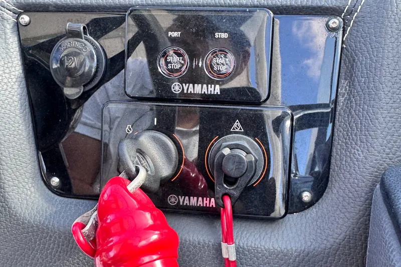 Slide: The Image of 2018 Regal 29 OBX boat dashboard with Yamaha controls and ignition switches. - 23