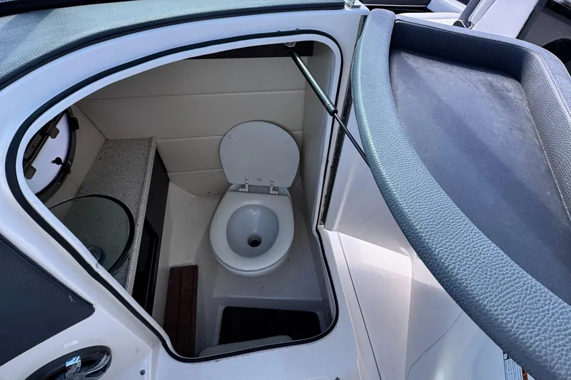 Slide: The Image of 2018 Regal 29 OBX boat interior bathroom with toilet and sink. - 26