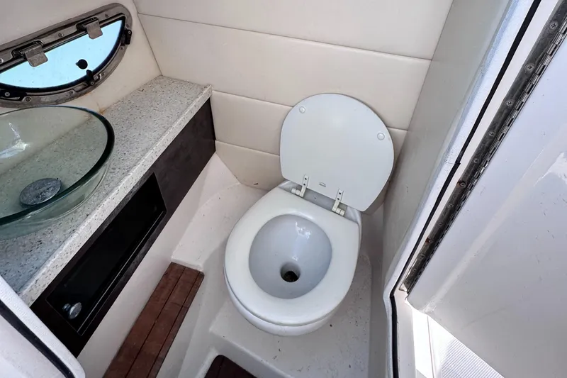 Slide: The Image of 2018 Regal 29 OBX boat bathroom with toilet and sink. - 27