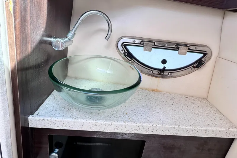 Slide: The Image of Glass sink and faucet in 2018 Regal 29 OBX boat interior. - 28