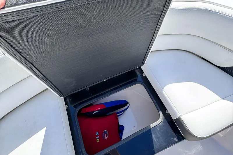 Slide: The Image of 2018 Regal 29 OBX boat storage compartment with life jacket inside. - 30