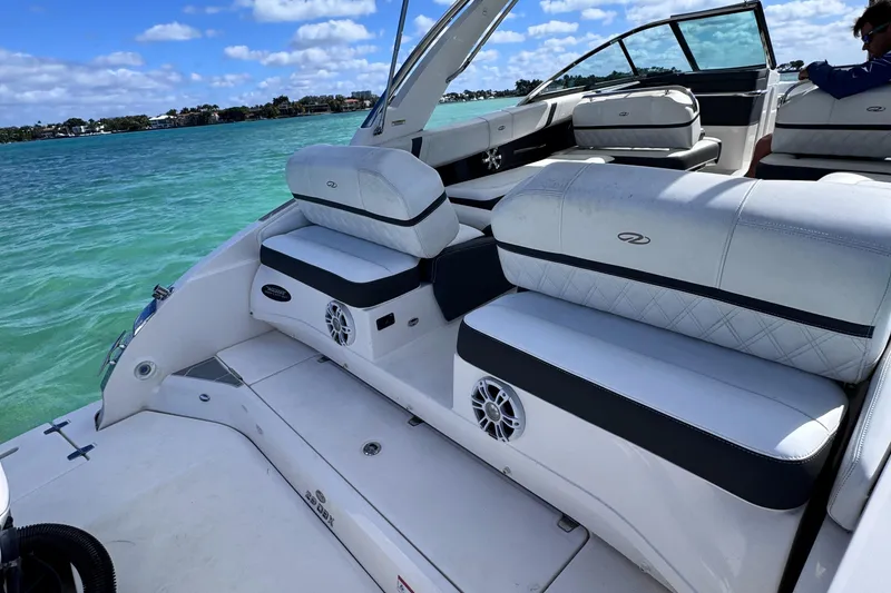 Slide: The Image of 2018 Regal 29 OBX boat interior with white seating on a sunny day. - 37