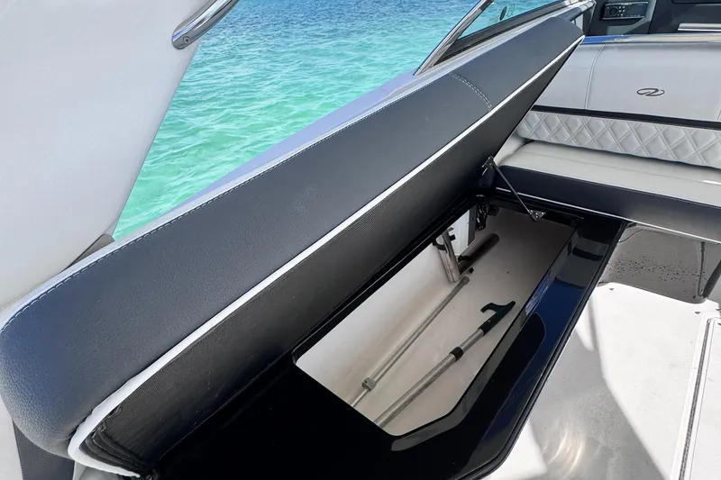Slide: The Image of 2018 Regal 29 OBX boat interior with open storage compartment by the sea. - 44