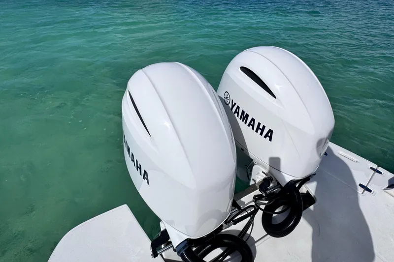Slide: The Image of Twin Yamaha outboard motors on 2018 Regal 29 OBX boat in clear water. - 45