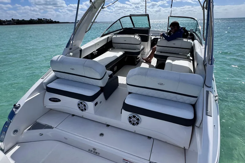 Slide: The Image of 2018 Regal 29 OBX boat on clear turquoise water, featuring spacious seating and sleek design. - 46