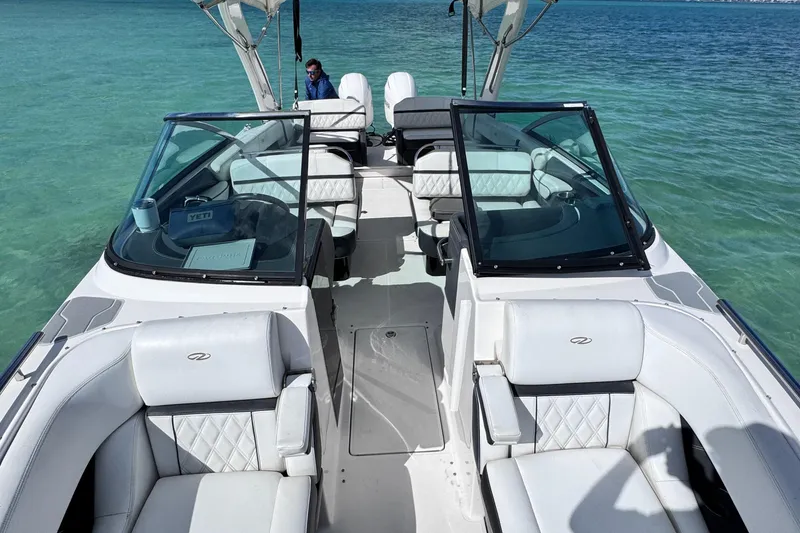 Slide: The Image of 2018 Regal 29 OBX boat with white seating on clear turquoise water. - 48